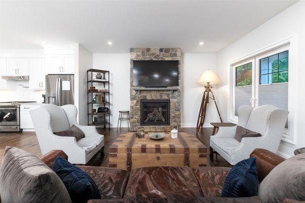Fireplace, Interior, Kitchen, Living room, Recessed Lighting, Stainless Steel Appliances, Stone Walls, Wood Texture Flooring