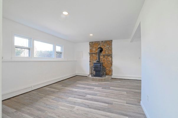 Empty room, Fireplace, Interior, Recessed Lighting, Stone Walls, Wood Texture Flooring