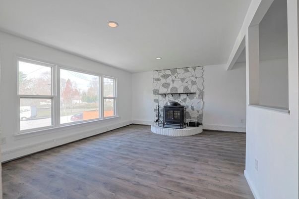 Empty room, Fireplace, Interior, Recessed Lighting, Stone Walls, Wood Texture Flooring