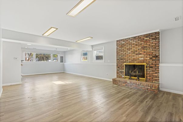 Empty room, Fireplace, Interior, Recessed Lighting, Stone Walls, Wood Texture Flooring