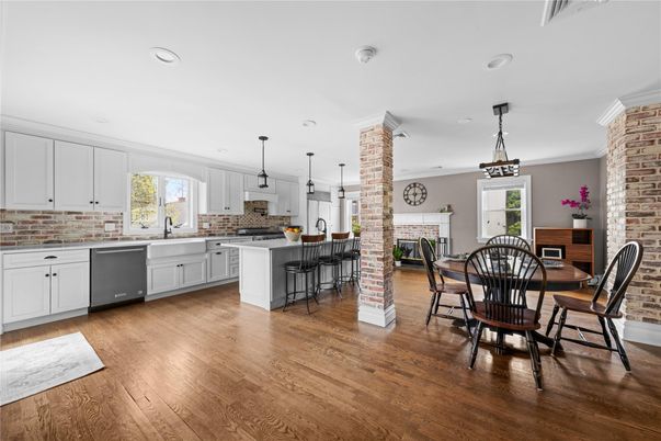 Dining room, Fireplace, Interior, Kitchen, Pendant Lights, Recessed Lighting, Stainless Steel Appliances, Stone Walls, Wood Texture Flooring