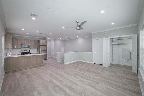 Empty room, Interior, Kitchen, Recessed Lighting, Stainless Steel Appliances, Wood Texture Flooring