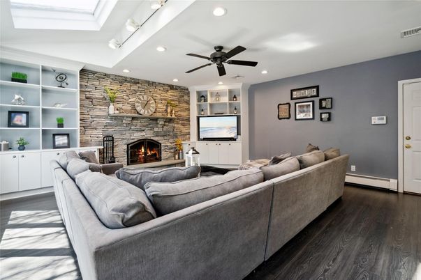Fireplace, Interior, Living room, Recessed Lighting, Stone Walls, Wood Texture Flooring