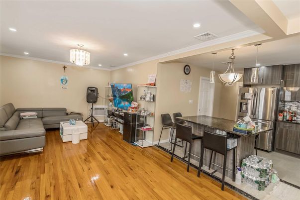Chandelier, Dining room, Interior, Kitchen, Living room, Pendant Lights, Recessed Lighting, Stainless Steel Appliances, Wood Texture Flooring