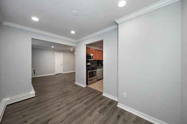 Empty room, Interior, Kitchen, Recessed Lighting, Stainless Steel Appliances, Wood Texture Flooring