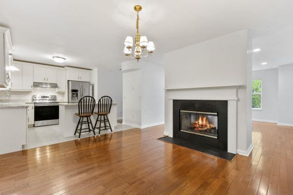 Chandelier, Fireplace, Interior, Kitchen, Recessed Lighting, Stainless Steel Appliances, Wood Texture Flooring