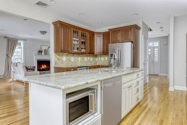 Fireplace, Interior, Kitchen, Recessed Lighting, Stainless Steel Appliances, Wood Texture Flooring