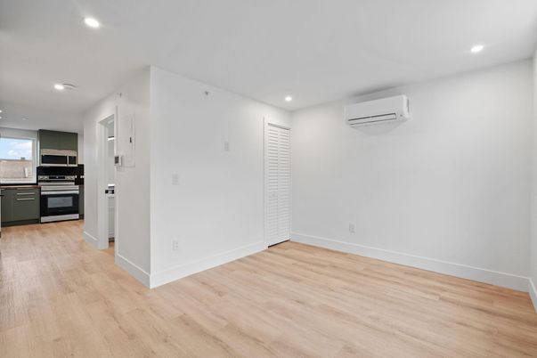 Empty room, Interior, Kitchen, Recessed Lighting, Stainless Steel Appliances, Wood Texture Flooring