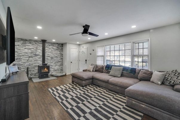 Fireplace, Interior, Living room, Recessed Lighting, Stone Walls, Wood Texture Flooring