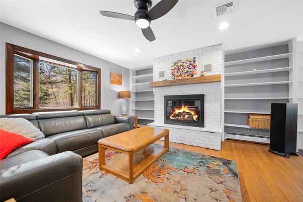 Fireplace, Interior, Living room, Recessed Lighting, Stone Walls, Wood Texture Flooring