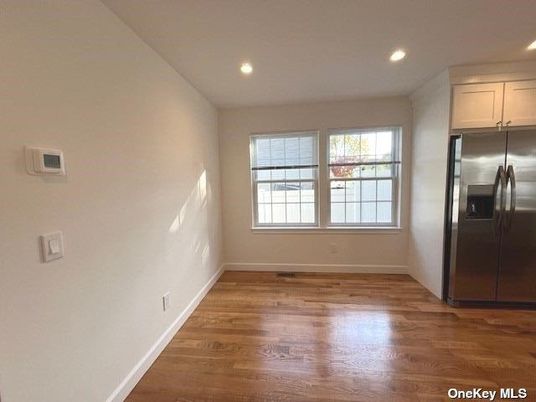 Empty room, Interior, Kitchen, Recessed Lighting, Stainless Steel Appliances, Wood Texture Flooring