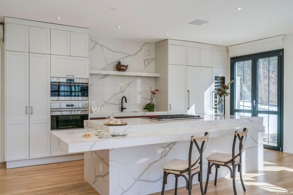 Interior, Kitchen, Marble Walls, Recessed Lighting, Stainless Steel Appliances, Wood Texture Flooring