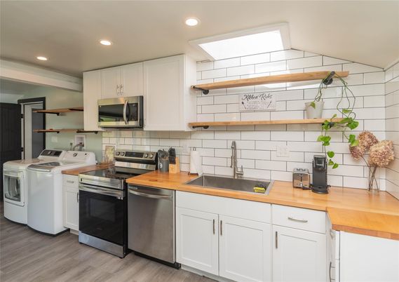 Interior, Kitchen, Recessed Lighting, Washer, Wood Texture Flooring
