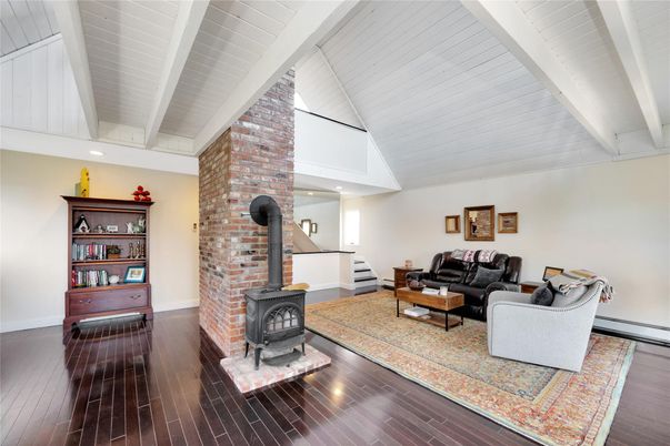 Fireplace, Interior, Living room, Recessed Lighting, Stone Walls, Wood Texture Flooring