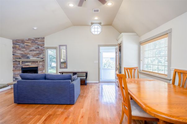 Dining room, Fireplace, Interior, Living room, Recessed Lighting, Stone Walls, Wood Texture Flooring