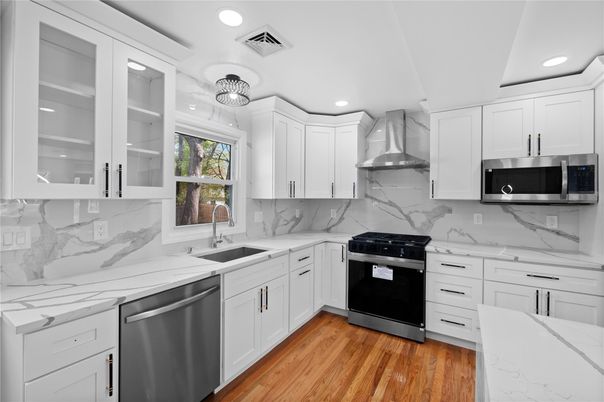Interior, Kitchen, Marble Walls, Recessed Lighting, Stainless Steel Appliances, Wood Texture Flooring