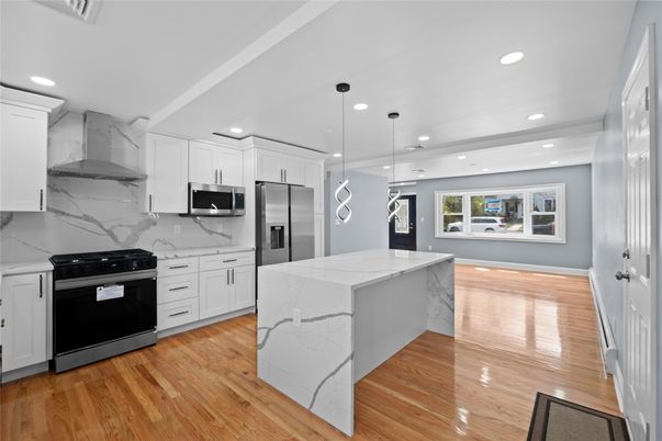 Interior, Kitchen, Marble Walls, Pendant Lights, Recessed Lighting, Stainless Steel Appliances, Wood Texture Flooring