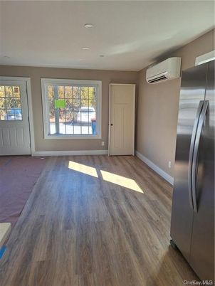 Empty room, Interior, Kitchen, Recessed Lighting, Stainless Steel Appliances, Wood Texture Flooring