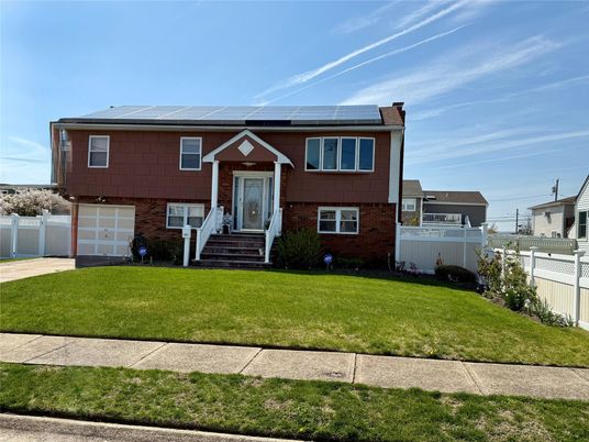 Attached, Exterior, Facade, Brick Facade, Solar Panels, Raised Ranch