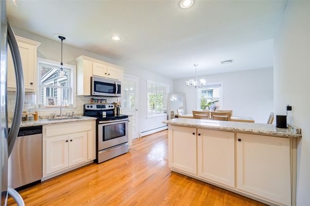Chandelier, Dining room, Interior, Kitchen, Pendant Lights, Recessed Lighting, Stainless Steel Appliances, Wood Texture Flooring