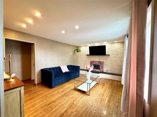 Fireplace, Interior, Living room, Recessed Lighting, Stone Walls, Wood Texture Flooring
