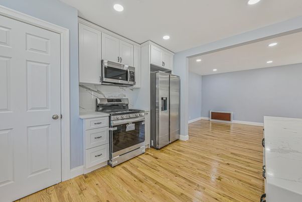 Interior, Kitchen, Marble Walls, Recessed Lighting, Stainless Steel Appliances, Wood Texture Flooring