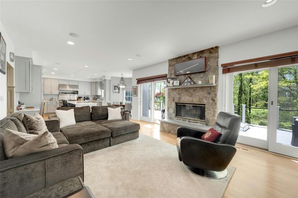 Fireplace, Interior, Kitchen, Living room, Pendant Lights, Recessed Lighting, Stainless Steel Appliances, Stone Walls, Wood Texture Flooring