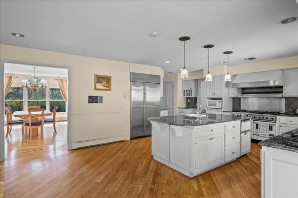 Chandelier, Dining room, Interior, Kitchen, Pendant Lights, Recessed Lighting, Stainless Steel Appliances, Wood Texture Flooring