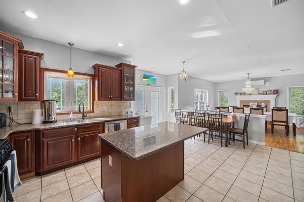 Chandelier, Dining room, Fireplace, Interior, Kitchen, Pendant Lights, Recessed Lighting, Stainless Steel Appliances, Wood Texture Flooring