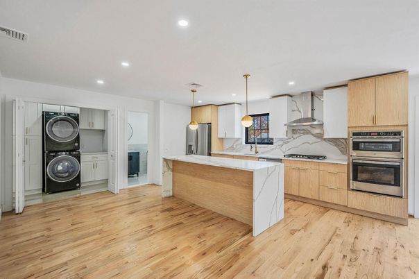 Interior, Kitchen, Marble Walls, Pendant Lights, Recessed Lighting, Stainless Steel Appliances, Wood Texture Flooring