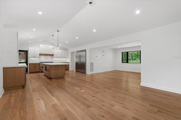 Empty room, Interior, Kitchen, Pendant Lights, Recessed Lighting, Stainless Steel Appliances, Wood Texture Flooring