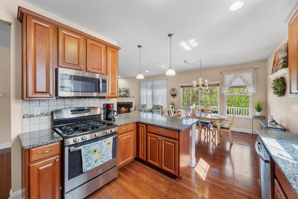 Dining room, Fireplace, Interior, Kitchen, Pendant Lights, Recessed Lighting, Stainless Steel Appliances, Wood Texture Flooring