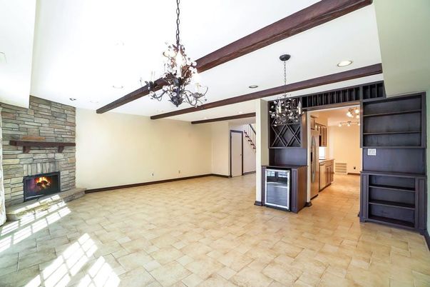 Chandelier, Empty room, Fireplace, Interior, Pendant Lights, Recessed Lighting, Wooden Beams