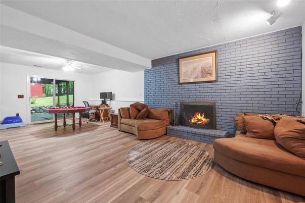 Fireplace, Game Room, Interior, Living room, Stone Walls, Wood Texture Flooring