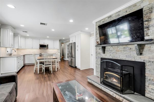 Dining room, Fireplace, Interior, Kitchen, Recessed Lighting, Stainless Steel Appliances, Wood Texture Flooring