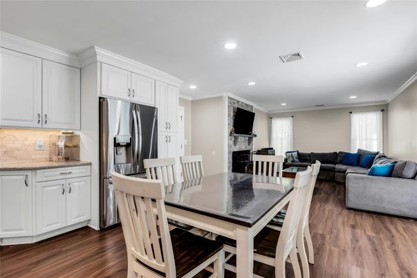 Dining room, Fireplace, Interior, Kitchen, Living room, Recessed Lighting, Stainless Steel Appliances, Wood Texture Flooring