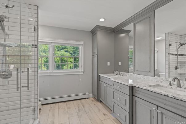 Bathroom, Dual Sink Vanities, Glass Shower, Interior, Recessed Lighting, Wood Texture Flooring