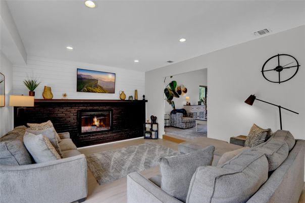 Fireplace, Interior, Living room, Recessed Lighting, Stone Walls, Wood Texture Flooring