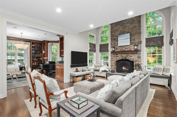 Chandelier, Fireplace, Interior, Living room, Piano, Recessed Lighting, Stone Walls, Wood Texture Flooring
