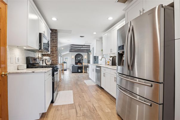 Fireplace, Interior, Kitchen, Recessed Lighting, Stainless Steel Appliances, Wood Texture Flooring