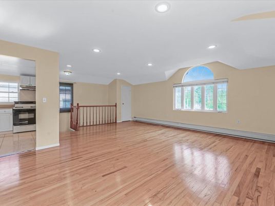 Empty room, Interior, Kitchen, Recessed Lighting, Stainless Steel Appliances, Wood Texture Flooring