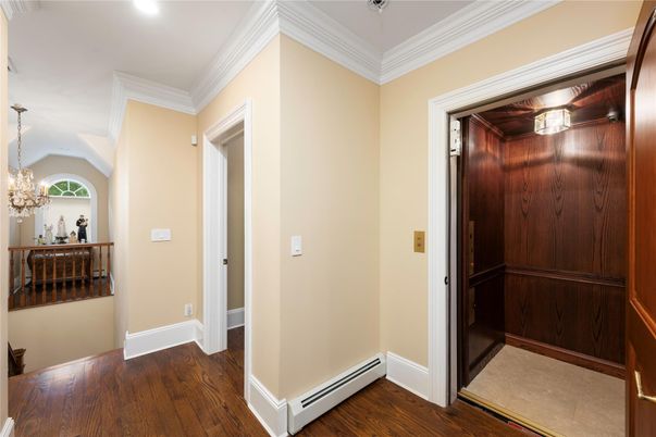 Chandelier, Elevator, Interior, Recessed Lighting, Wood Texture Flooring, Wooden Walls
