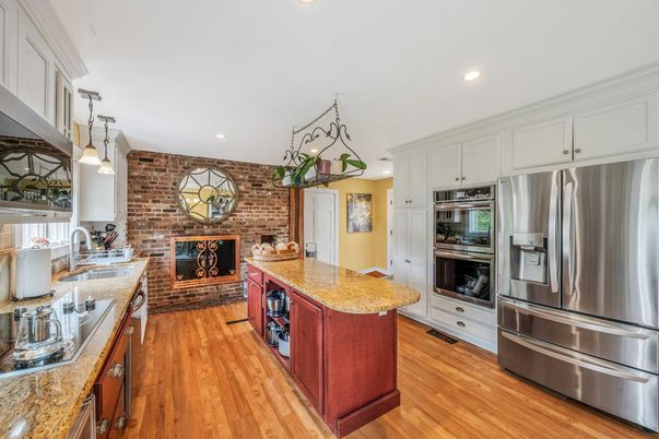 Fireplace, Interior, Kitchen, Pendant Lights, Recessed Lighting, Stainless Steel Appliances, Stone Walls, Wood Texture Flooring