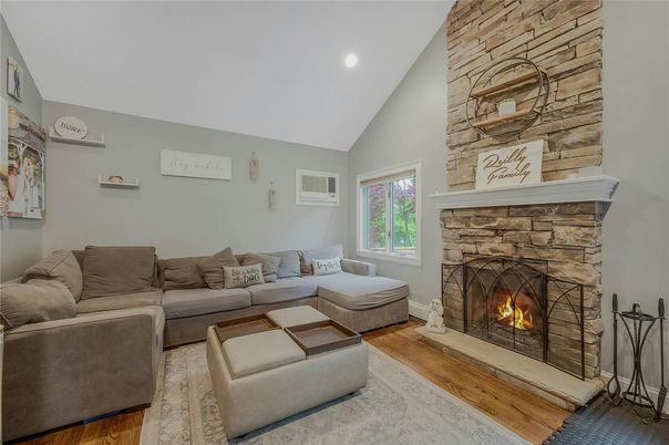 Fireplace, Interior, Living room, Recessed Lighting, Stone Walls, Wood Texture Flooring