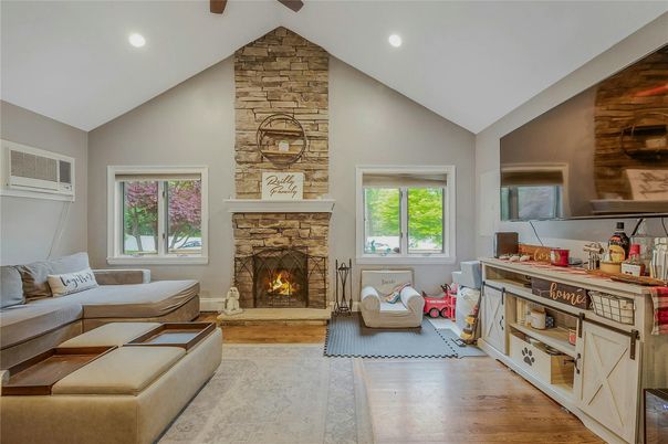 Fireplace, Interior, Living room, Recessed Lighting, Stone Walls, Wood Texture Flooring