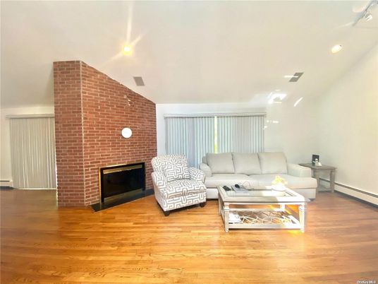 Fireplace, Interior, Living room, Recessed Lighting, Stone Walls, Wood Texture Flooring