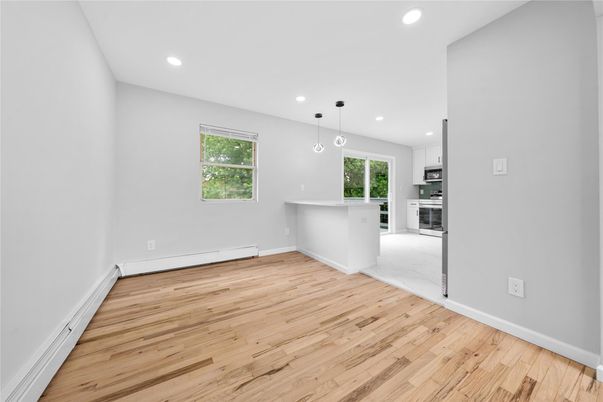 Empty room, Interior, Kitchen, Pendant Lights, Recessed Lighting, Stainless Steel Appliances, Wood Texture Flooring
