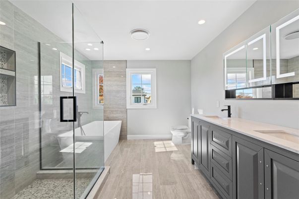 Bathroom, Dual Sink Vanities, Free Standing Baths, Glass Shower, Interior, Recessed Lighting, Wood Texture Flooring
