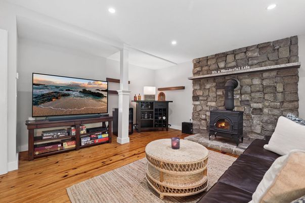 Fireplace, Interior, Living room, Recessed Lighting, Stone Walls, Wood Texture Flooring