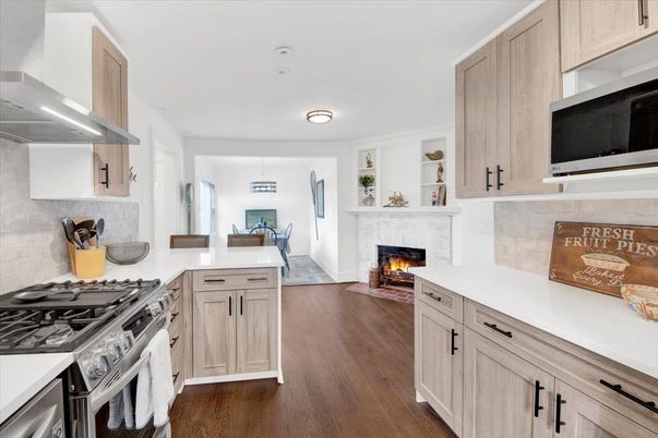 Dining room, Fireplace, Interior, Kitchen, Pendant Lights, Stainless Steel Appliances, Wood Texture Flooring